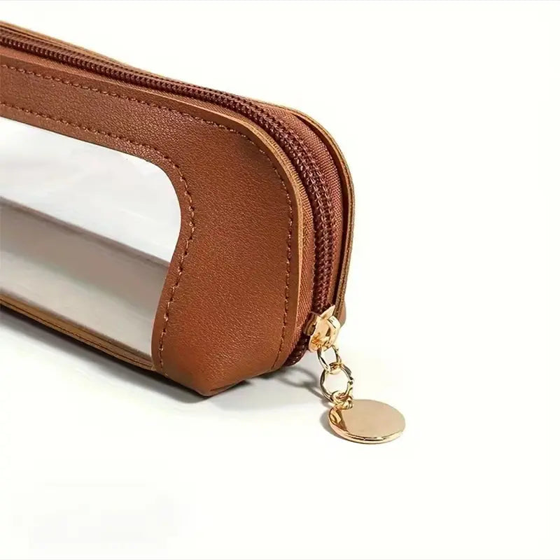 Portable Makeup Brush & Cosmetic Bag showcasing a brown zippered pouch with a transparent window and gold zipper pull.